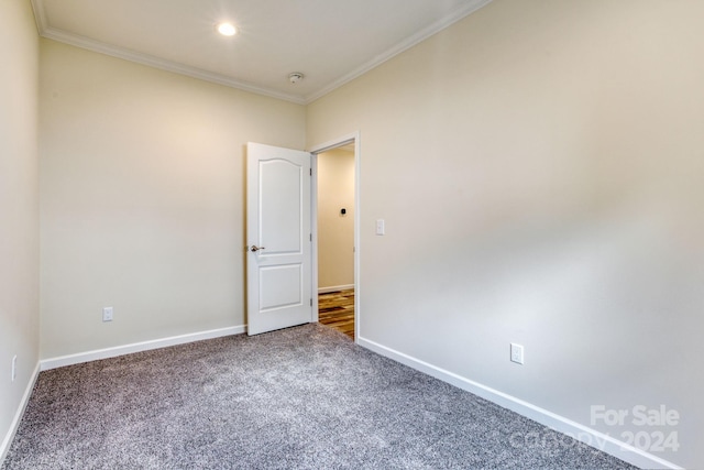 carpeted empty room featuring ornamental molding