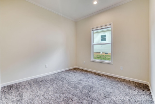 carpeted spare room featuring ornamental molding