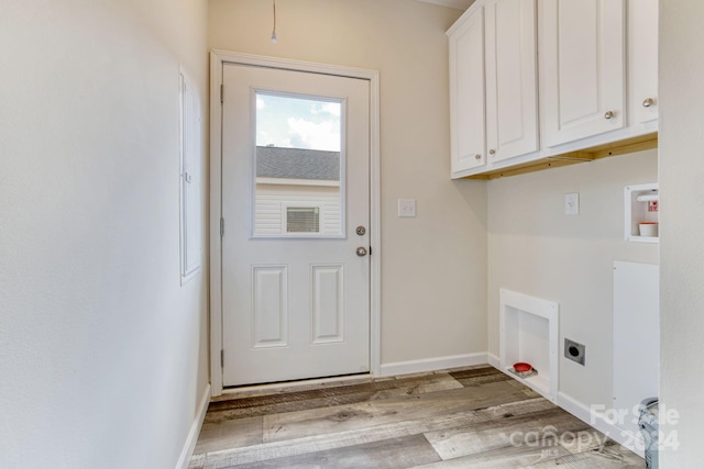 laundry area featuring cabinets, light wood-type flooring, and electric dryer hookup