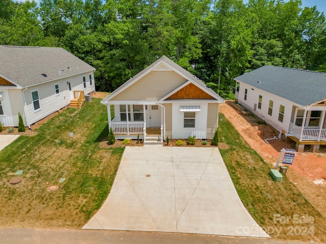 view of front of home with a front yard and covered porch