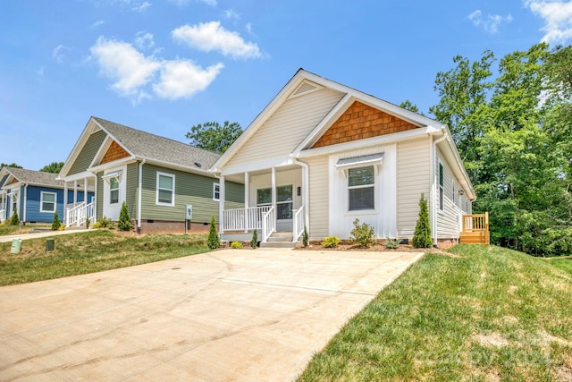 view of front of property with a porch and a front lawn