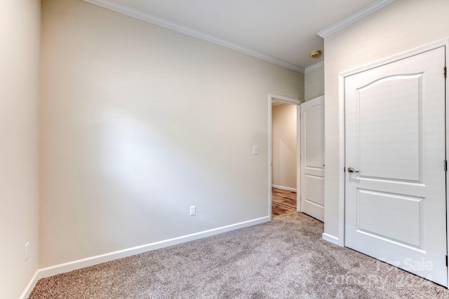 unfurnished bedroom featuring light colored carpet and ornamental molding