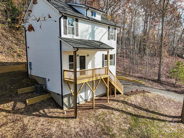 rear view of property with central AC