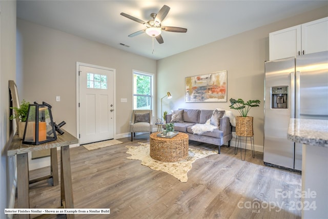 living room with light wood-type flooring and ceiling fan