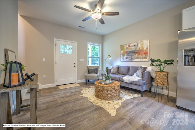 living room featuring hardwood / wood-style flooring and ceiling fan