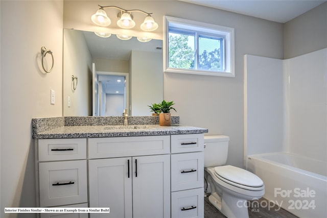 full bathroom with toilet, vanity, and shower / washtub combination