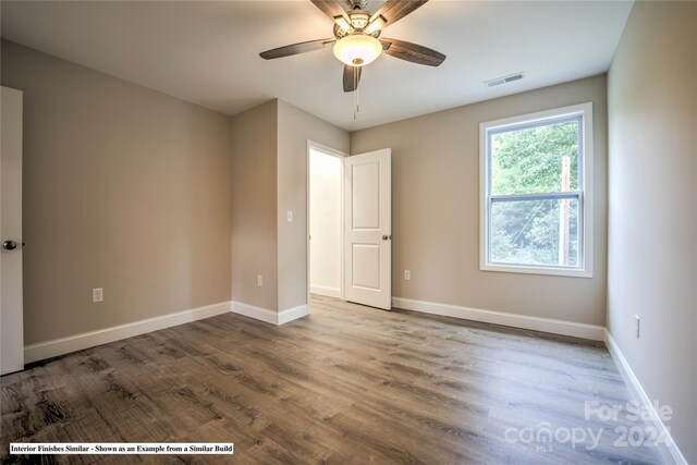 unfurnished room with hardwood / wood-style floors and ceiling fan