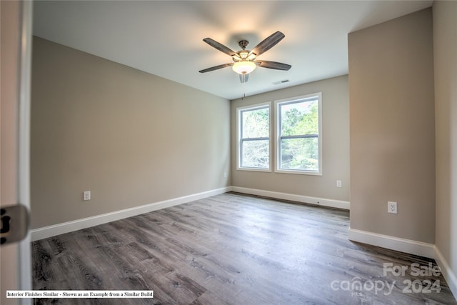 spare room with wood-type flooring and ceiling fan