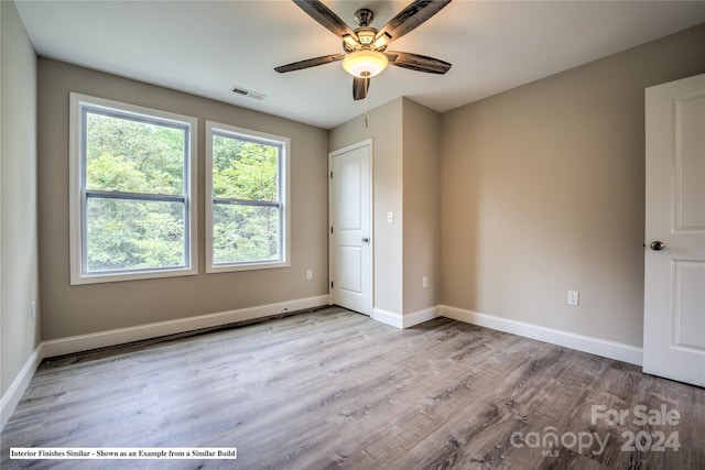 unfurnished bedroom with ceiling fan and light hardwood / wood-style flooring