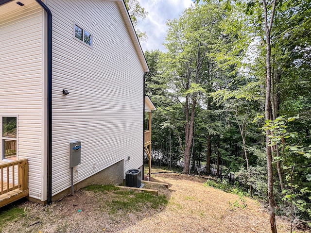 view of side of home with central AC unit