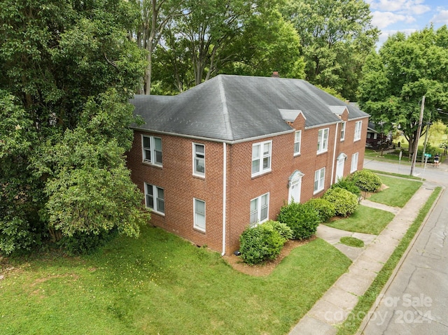 view of property exterior with a lawn