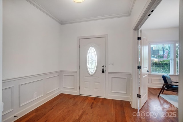 foyer entrance with hardwood / wood-style floors and ornamental molding