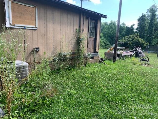 view of property exterior featuring cooling unit and a yard