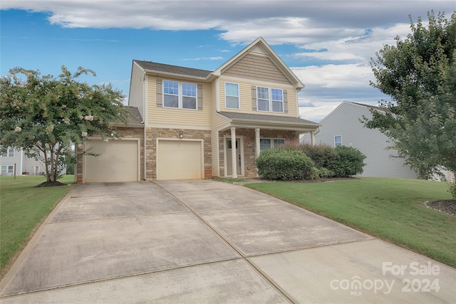 view of front of house featuring a garage and a front lawn