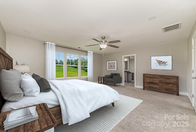 bedroom featuring ceiling fan, light carpet, and connected bathroom