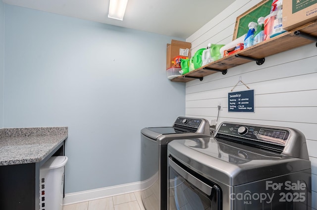 washroom featuring washing machine and dryer and light tile patterned flooring