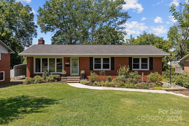 single story home with a carport and a front lawn