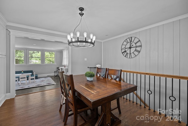 dining room featuring ornamental molding, a notable chandelier, and dark hardwood / wood-style floors