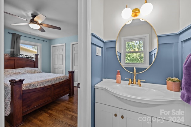 bathroom with ceiling fan, vanity, plenty of natural light, and wood-type flooring