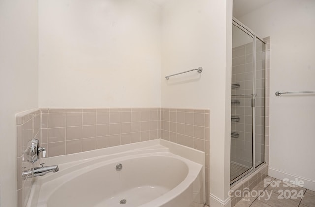 bathroom with tile patterned floors and independent shower and bath