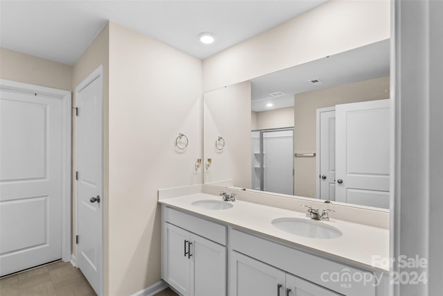 bathroom featuring walk in shower and vanity