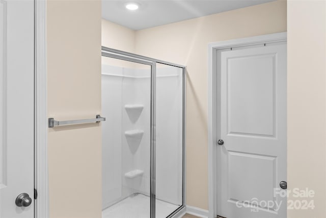 bathroom with a shower with shower door