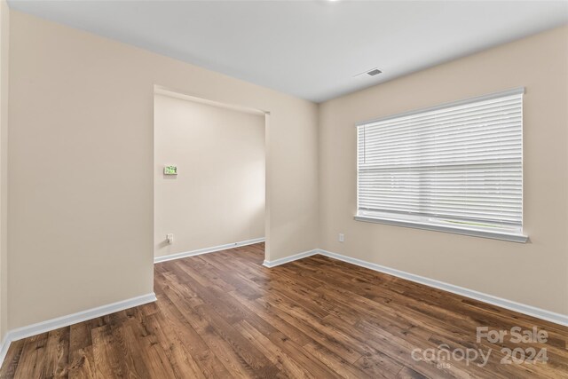 empty room with dark hardwood / wood-style floors