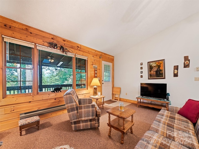 carpeted living room with lofted ceiling, a baseboard heating unit, and wood walls