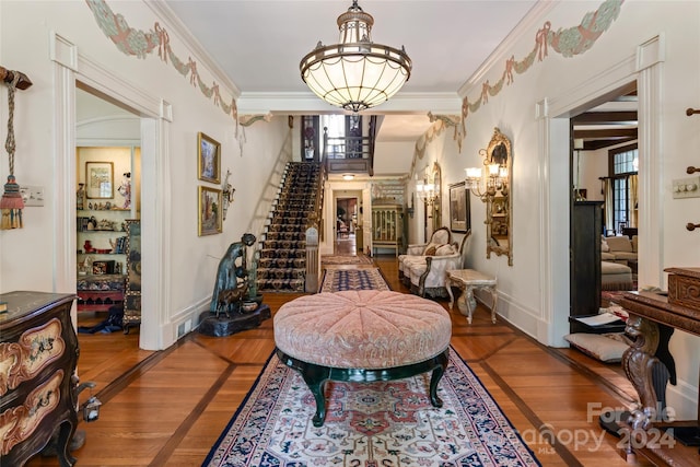 interior space featuring wood-type flooring, an inviting chandelier, and crown molding