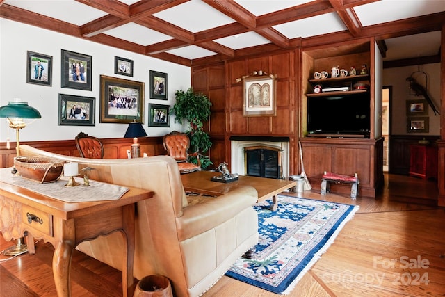 living room with coffered ceiling, wooden walls, wood-type flooring, beam ceiling, and built in shelves