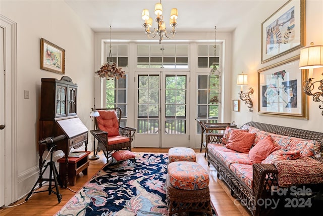 living area with hardwood / wood-style flooring and a notable chandelier