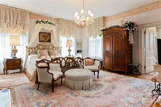 bedroom featuring hardwood / wood-style floors and a chandelier