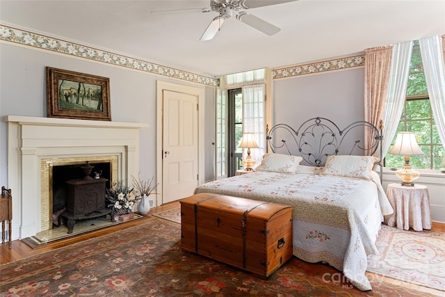 bedroom with ceiling fan and dark hardwood / wood-style floors