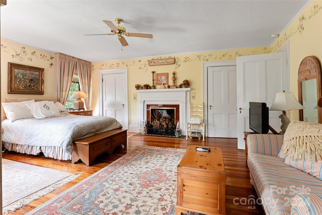 bedroom with ceiling fan and wood-type flooring