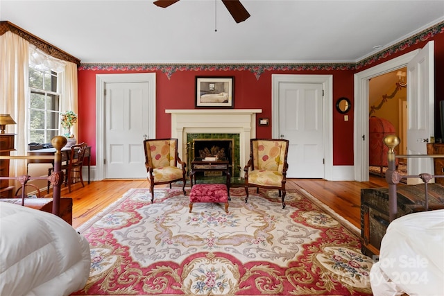 bedroom with ceiling fan, ornamental molding, and hardwood / wood-style flooring