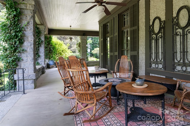 view of patio with ceiling fan and a fire pit