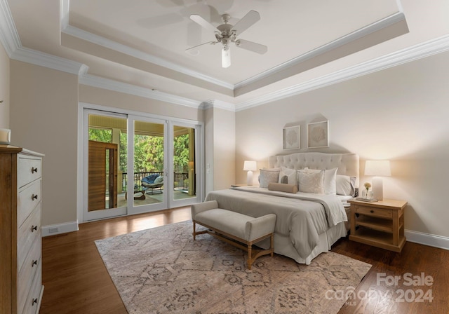 bedroom featuring ceiling fan, crown molding, access to outside, and a tray ceiling