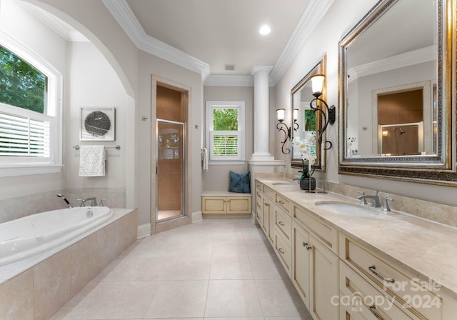 bathroom with decorative columns, tile patterned floors, ornamental molding, vanity, and plus walk in shower