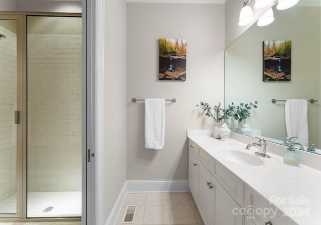 bathroom with tile patterned flooring, vanity, and an enclosed shower