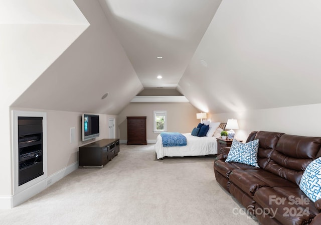 bedroom featuring light carpet and vaulted ceiling