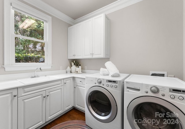 washroom featuring sink, cabinets, dark hardwood / wood-style flooring, washer and dryer, and ornamental molding