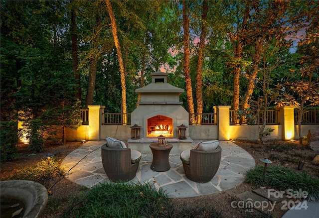 view of patio featuring exterior fireplace