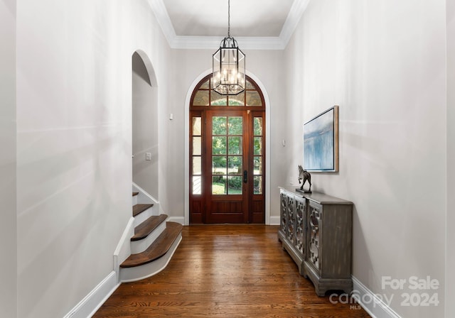 entrance foyer with a chandelier, dark hardwood / wood-style floors, and crown molding