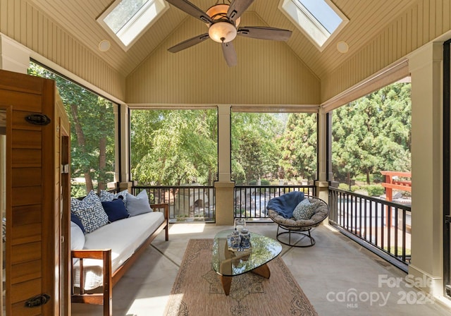 sunroom featuring lofted ceiling with skylight and ceiling fan