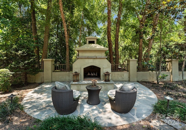 view of patio / terrace featuring an outdoor fireplace