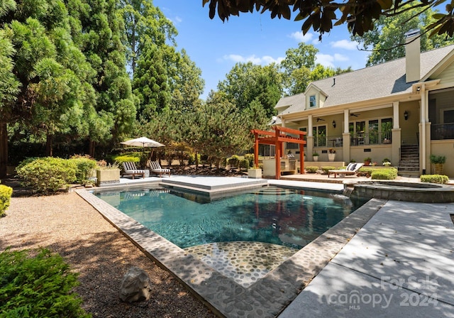 view of swimming pool with ceiling fan and a patio area