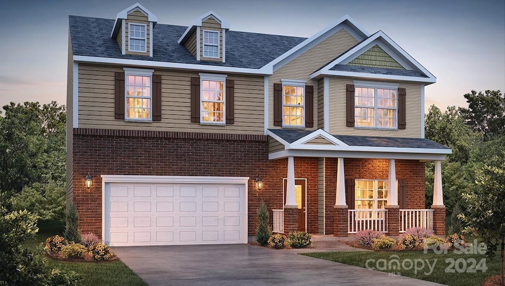 craftsman inspired home featuring a porch and a garage