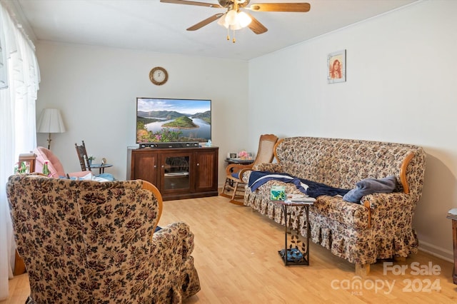 sitting room with ceiling fan and light wood-type flooring