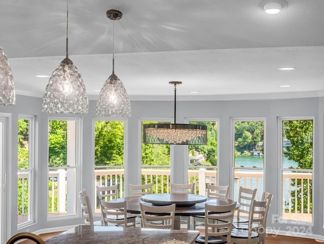 sunroom featuring a water view and a wealth of natural light