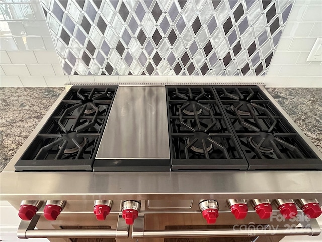 kitchen featuring stone counters and high end stove